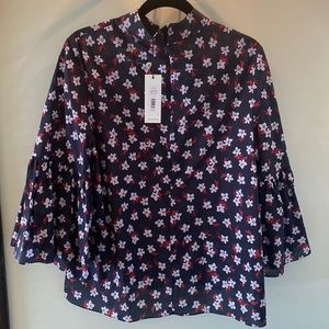 Adam Lippes high neck floral blouse with bell short sleeves.